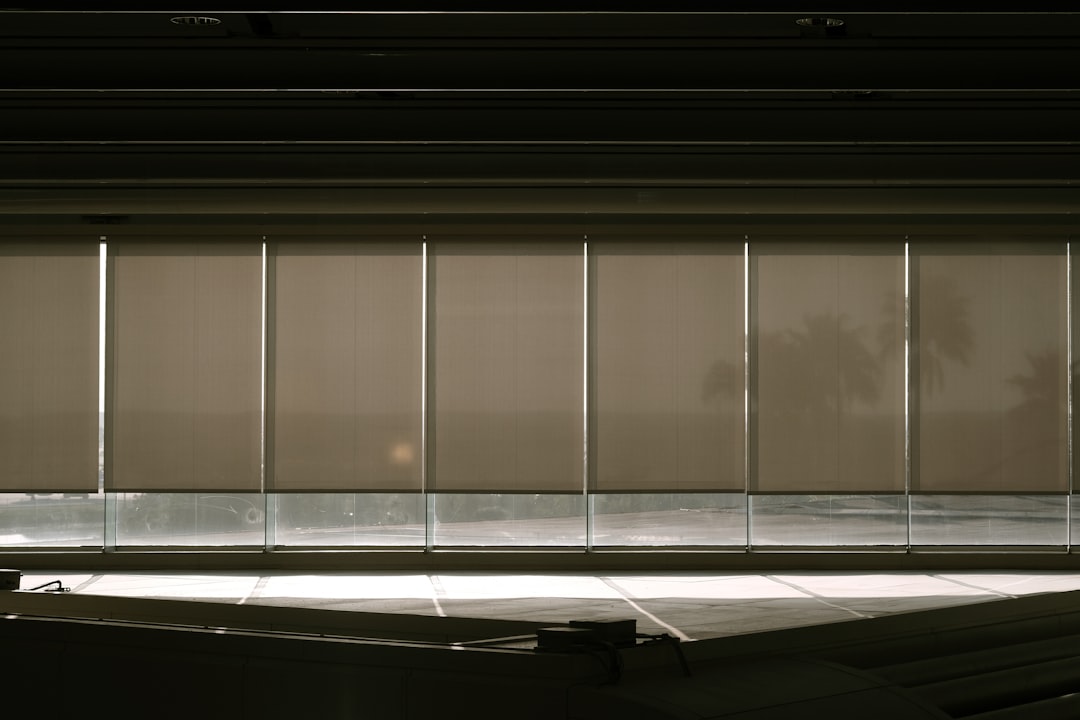 a-window-with-blinds-in-a-dark-room-iy1w2ektts